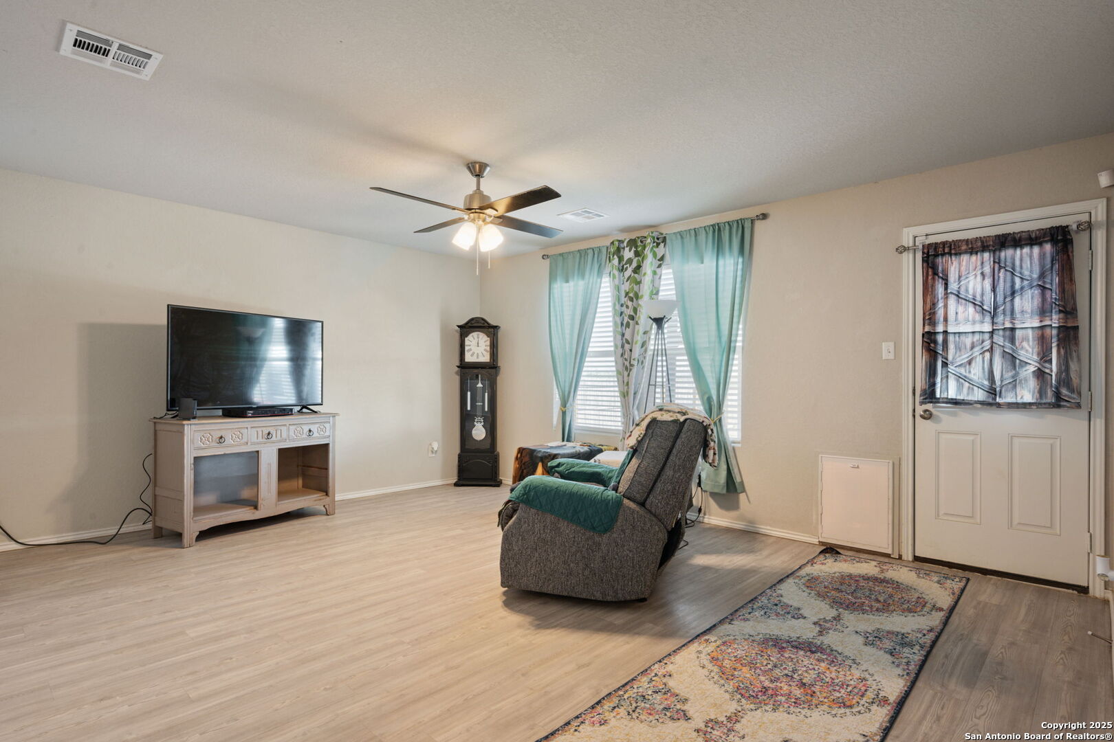 439 Agave Circle Jourdanton, TX 78026 - Photo 12 of 27 a living room with furniture and a flat screen tv