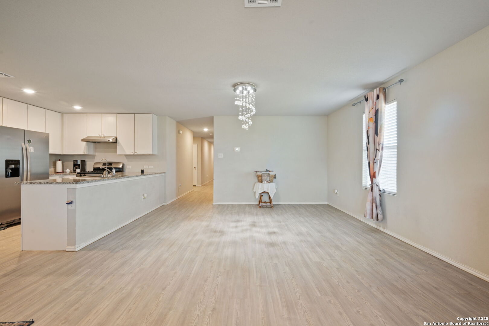 439 Agave Circle Jourdanton, TX 78026 - Photo 14 of 27 a view of a kitchen with wooden floor and electronic appliances