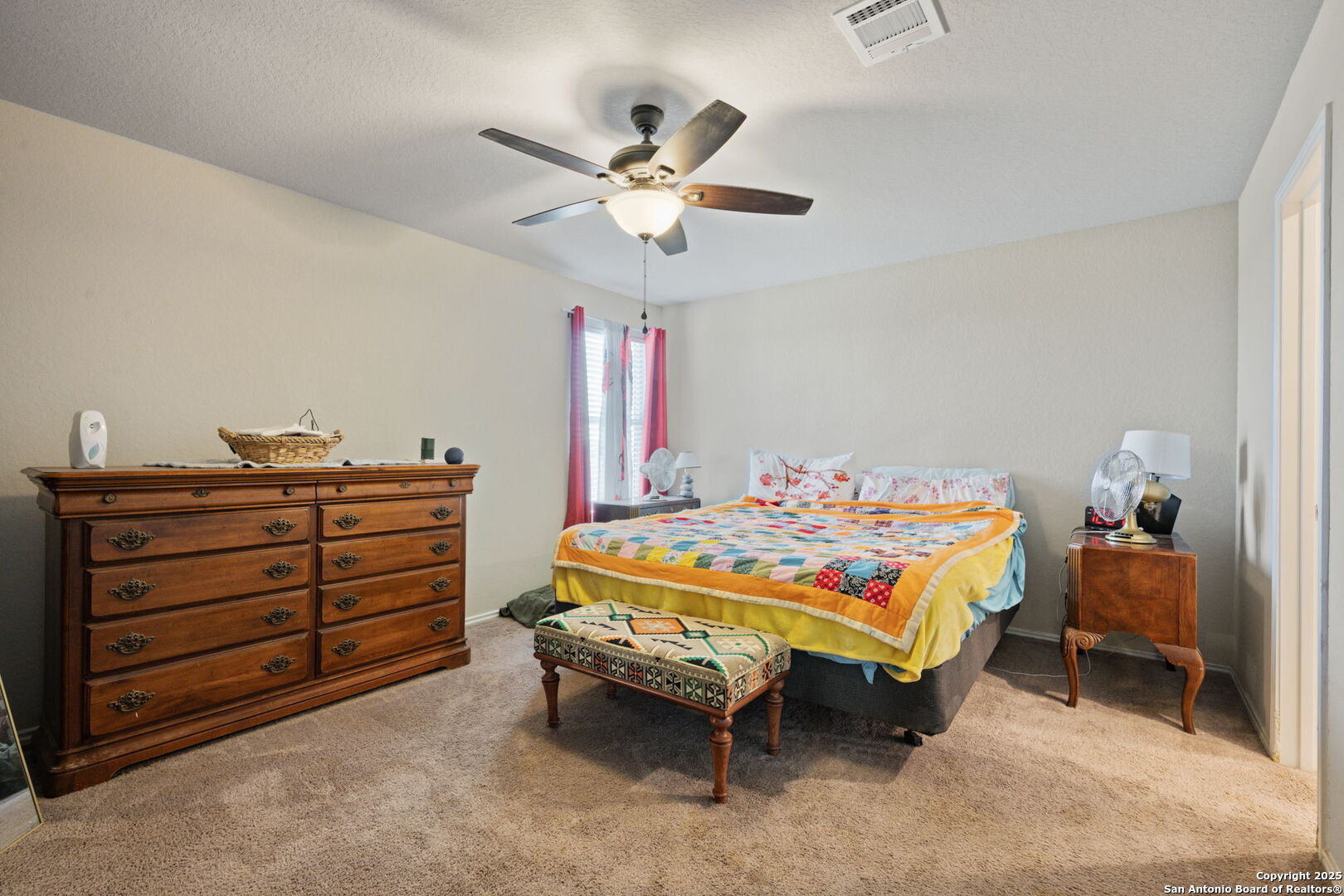 439 Agave Circle Jourdanton, TX 78026 - Photo 15 of 27 a bedroom with a bed and a chandelier