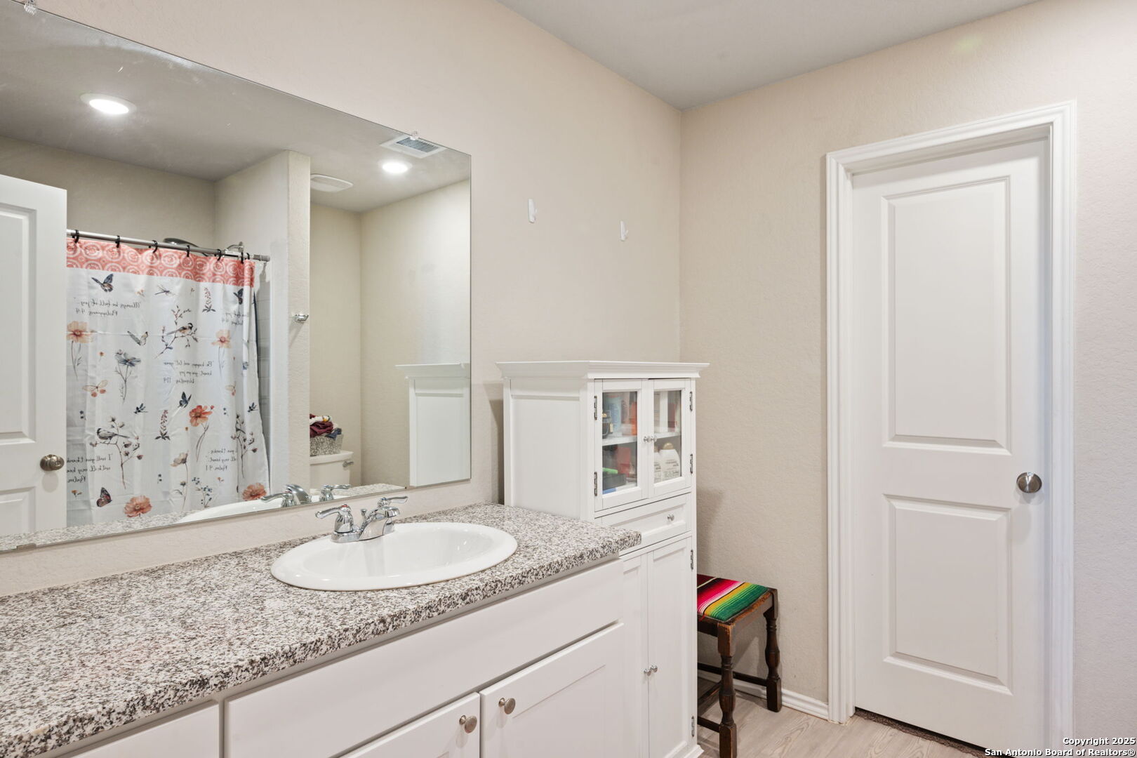 439 Agave Circle Jourdanton, TX 78026 - Photo 17 of 27 a bathroom with a granite countertop sink a mirror and shower