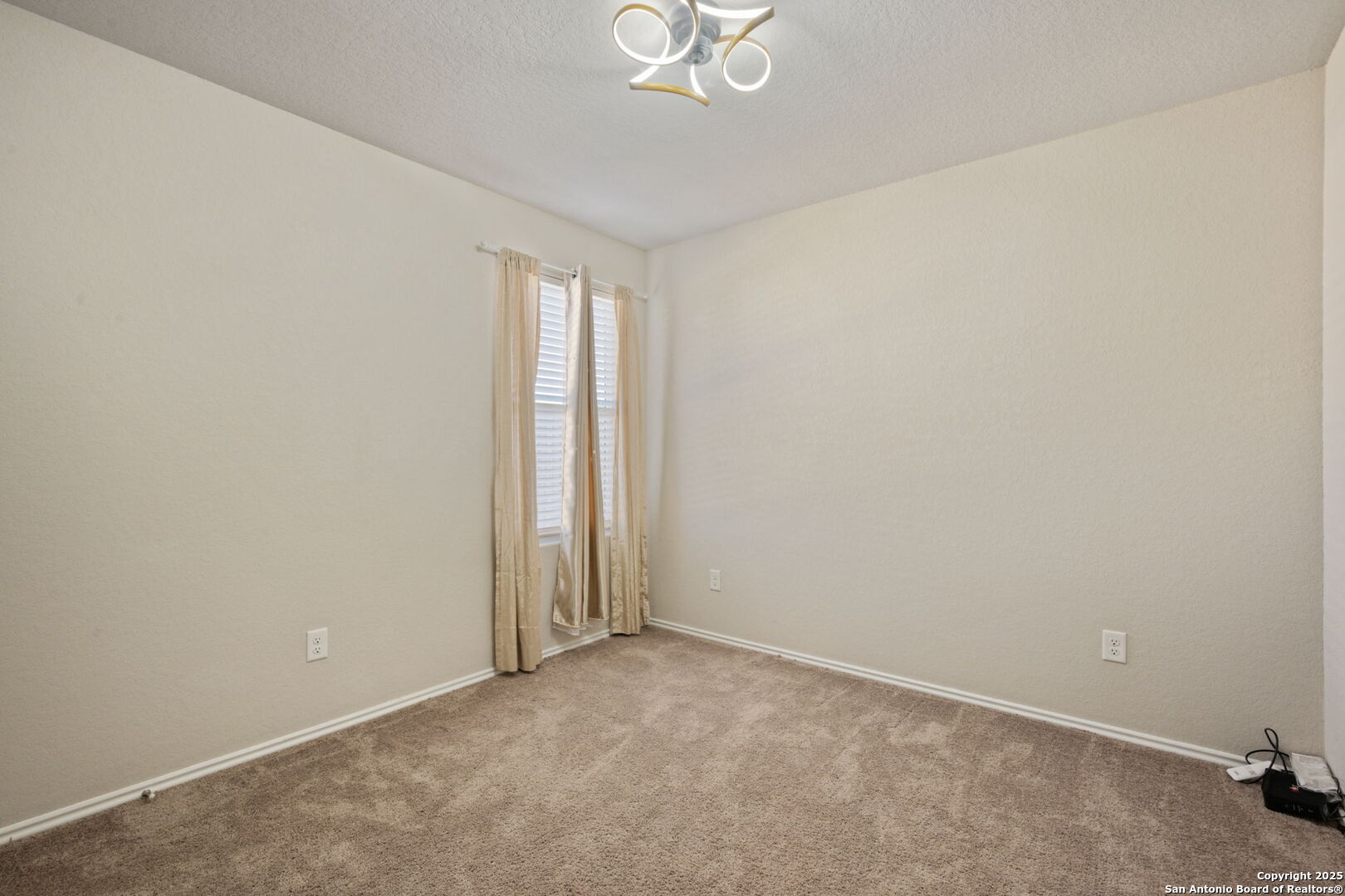 439 Agave Circle Jourdanton, TX 78026 - Photo 23 of 27 an empty room with a empty space and a window