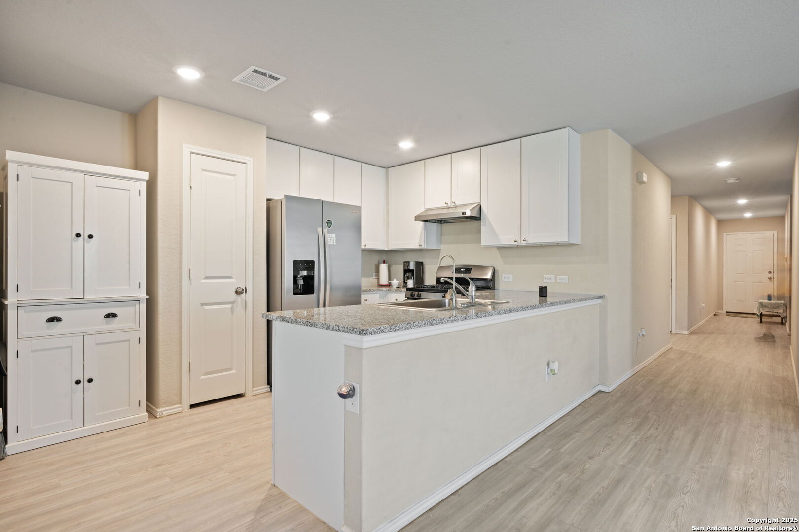 439 Agave Circle Jourdanton, TX 78026 - Photo 6 of 27 a kitchen with cabinets and stainless steel appliances