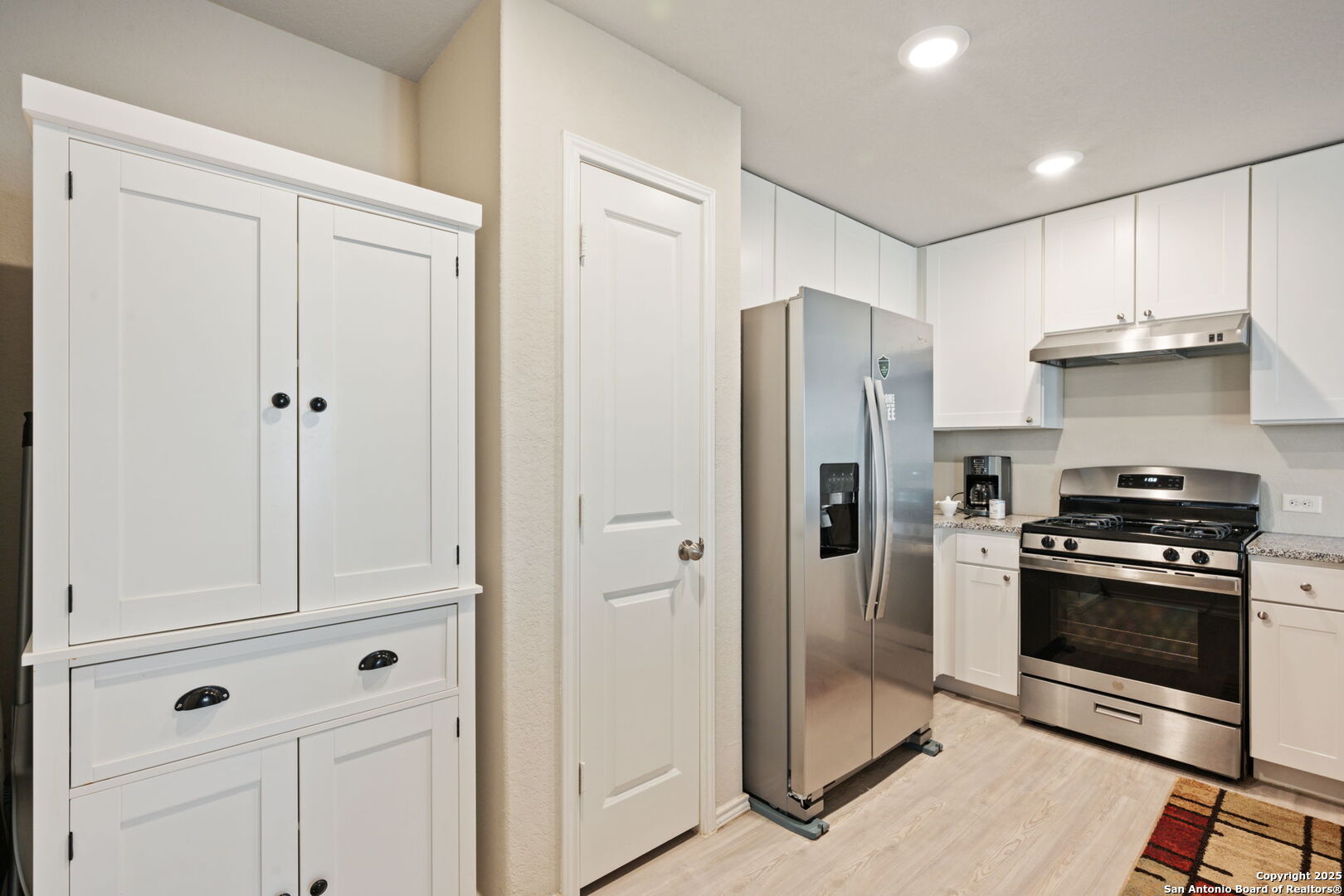 439 Agave Circle Jourdanton, TX 78026 - Photo 8 of 27 a kitchen with stainless steel appliances granite countertop white cabinets and refrigerator