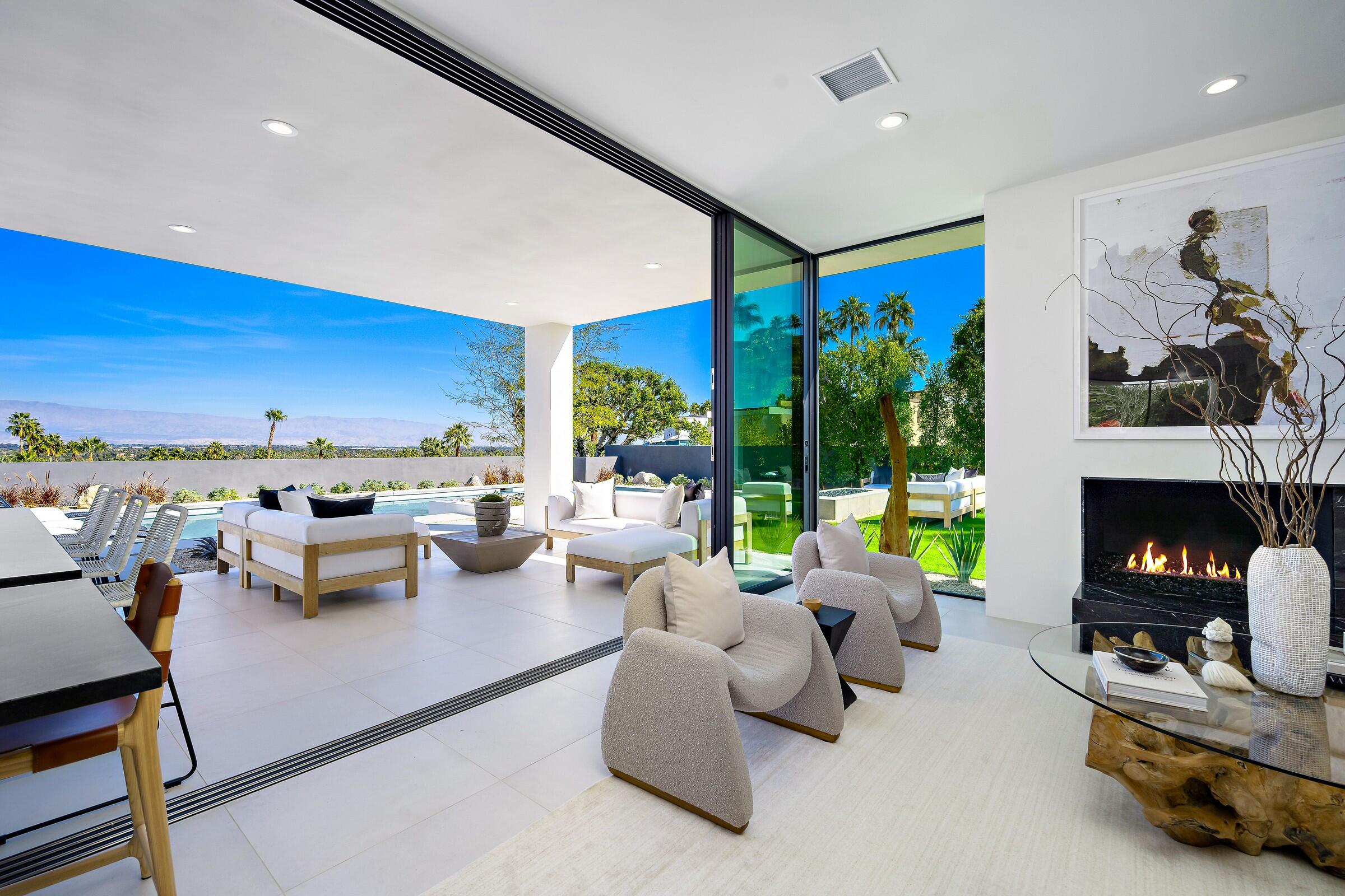 70345 Pecos Road Rancho Mirage, CA 92270 - Photo 21 of 72 a living room with furniture fireplace and floor to ceiling window