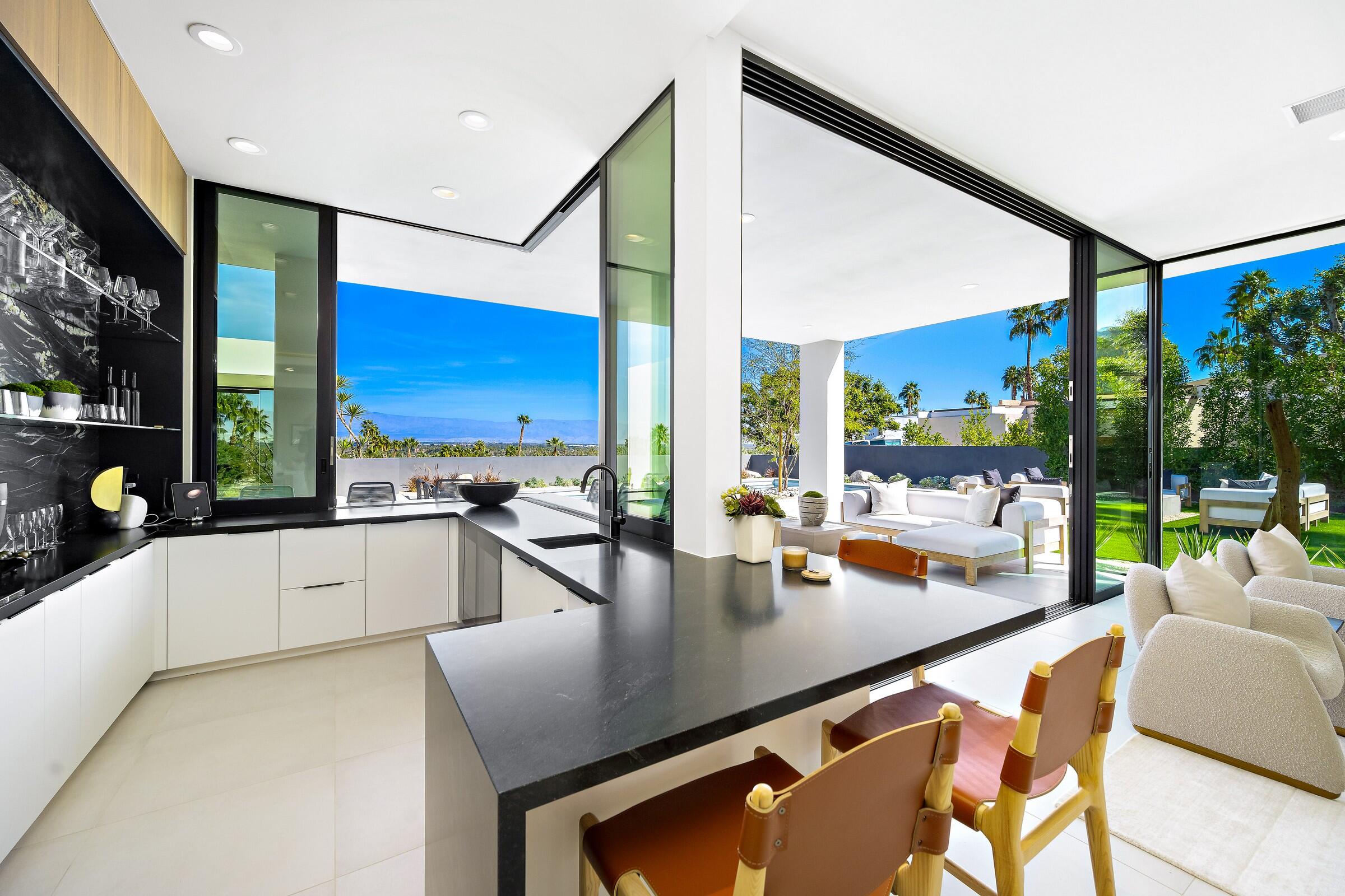 70345 Pecos Road Rancho Mirage, CA 92270 - Photo 24 of 72 a large kitchen with stainless steel appliances a large window and cabinets