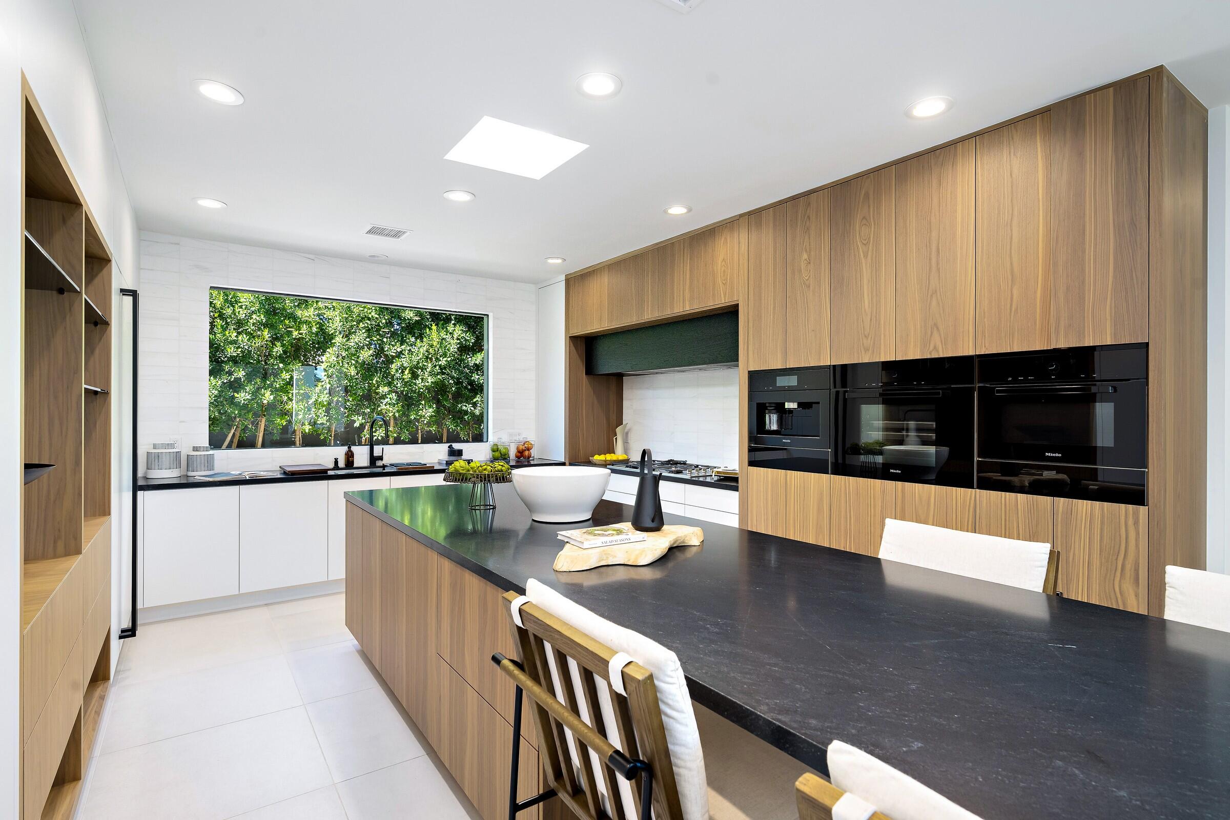 70345 Pecos Road Rancho Mirage, CA 92270 - Photo 33 of 72 a kitchen with stainless steel appliances granite countertop a stove a sink and a refrigerator