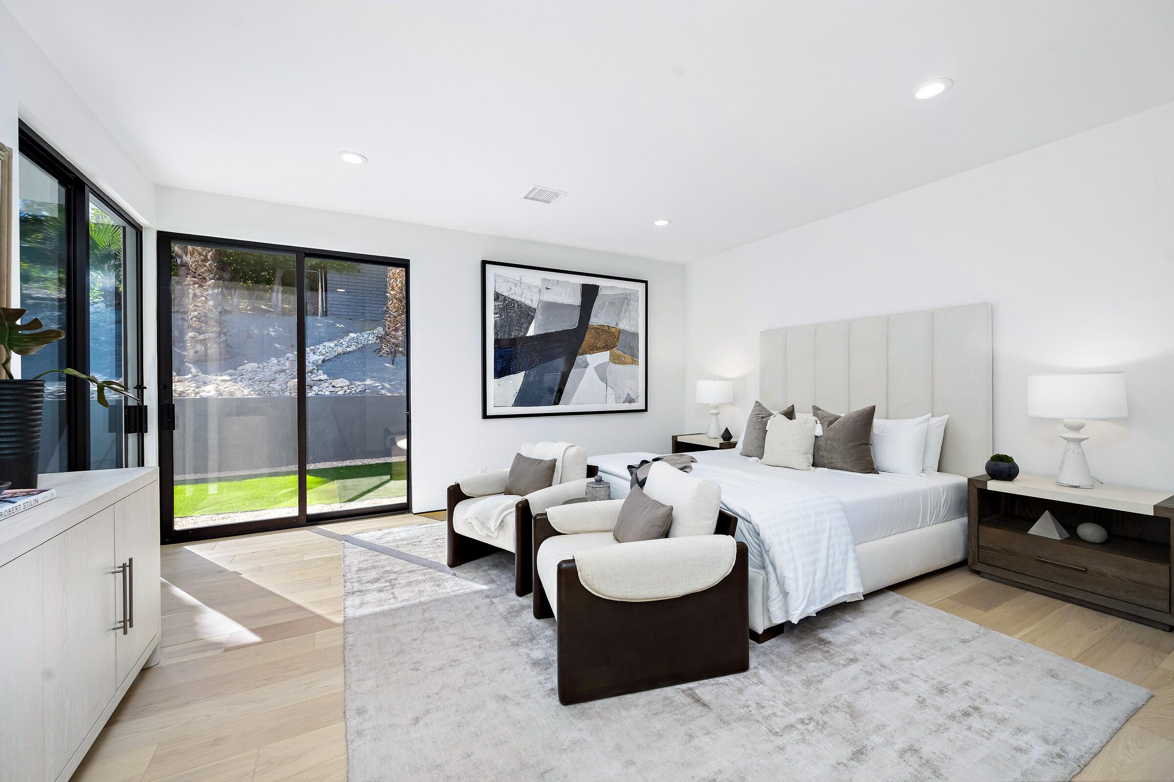 70345 Pecos Road Rancho Mirage, CA 92270 - Photo 54 of 72 a spacious bedroom with a bed and glass door