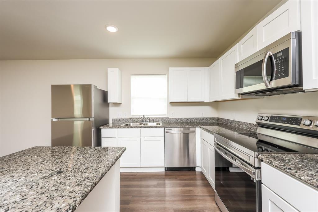 5108 Kilpatrick Avenue Fort Worth, TX 76107 - Photo 11 of 21 a kitchen with stainless steel appliances granite countertop a sink stove and refrigerator