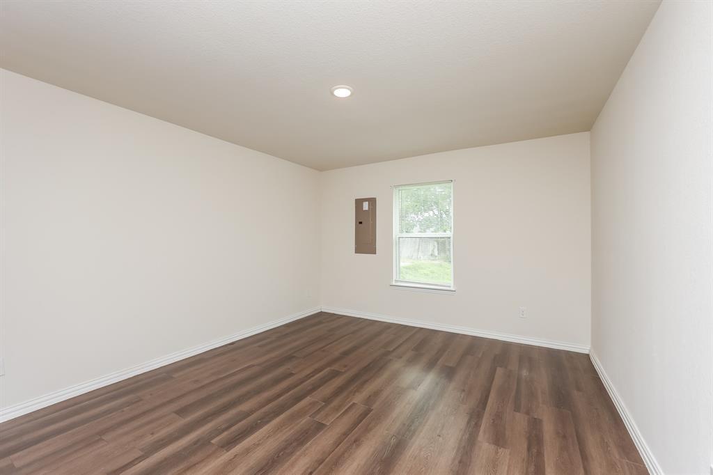 5108 Kilpatrick Avenue Fort Worth, TX 76107 - Photo 12 of 21 an empty room with wooden floor and windows