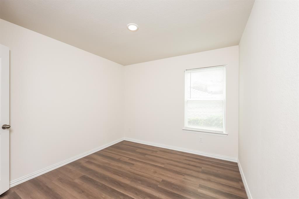 5108 Kilpatrick Avenue Fort Worth, TX 76107 - Photo 15 of 21 an empty room with wooden floor and windows