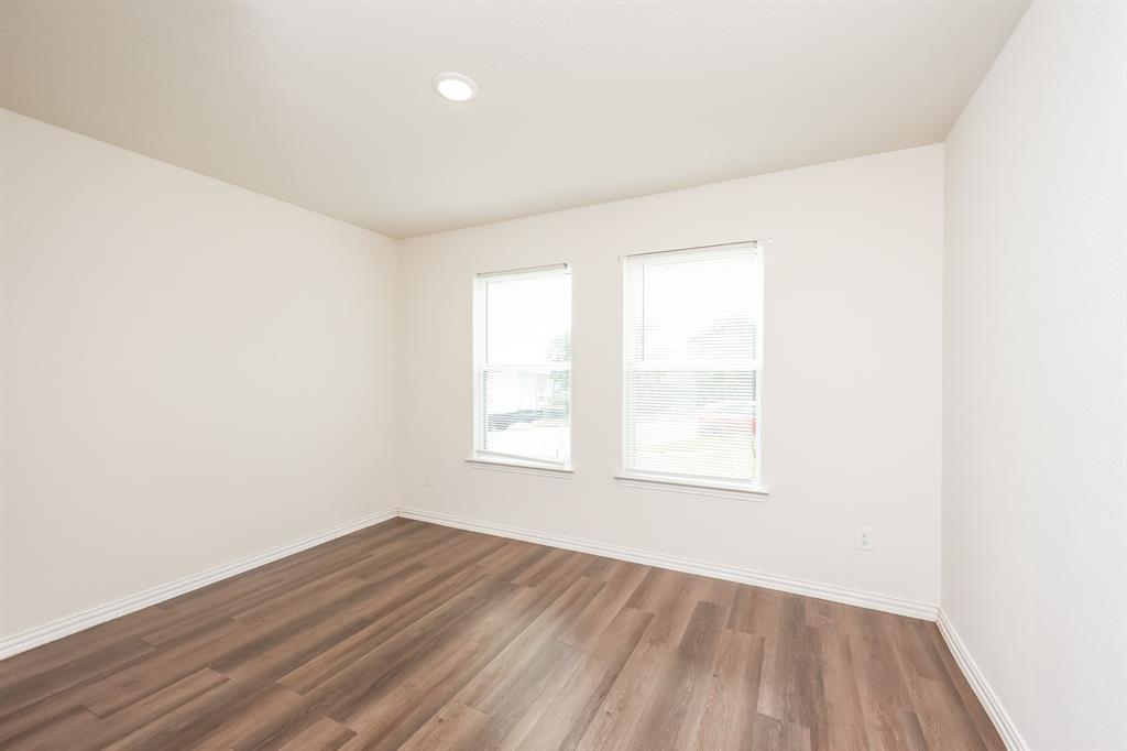 5108 Kilpatrick Avenue Fort Worth, TX 76107 - Photo 16 of 21 an empty room with wooden floor and windows