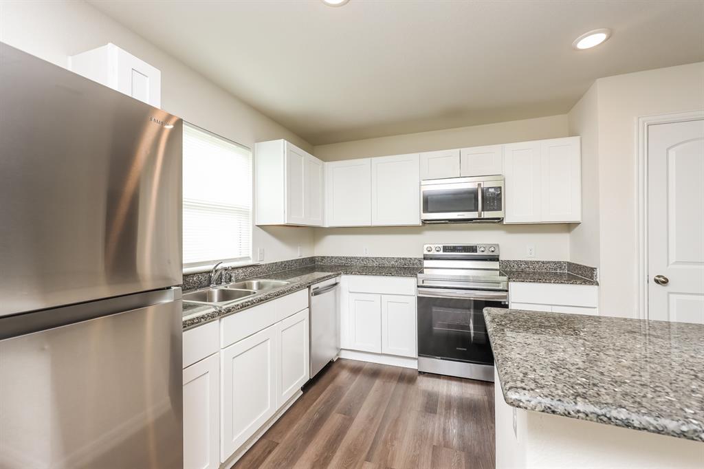5108 Kilpatrick Avenue Fort Worth, TX 76107 - Photo 8 of 21 a kitchen with a sink stove and refrigerator