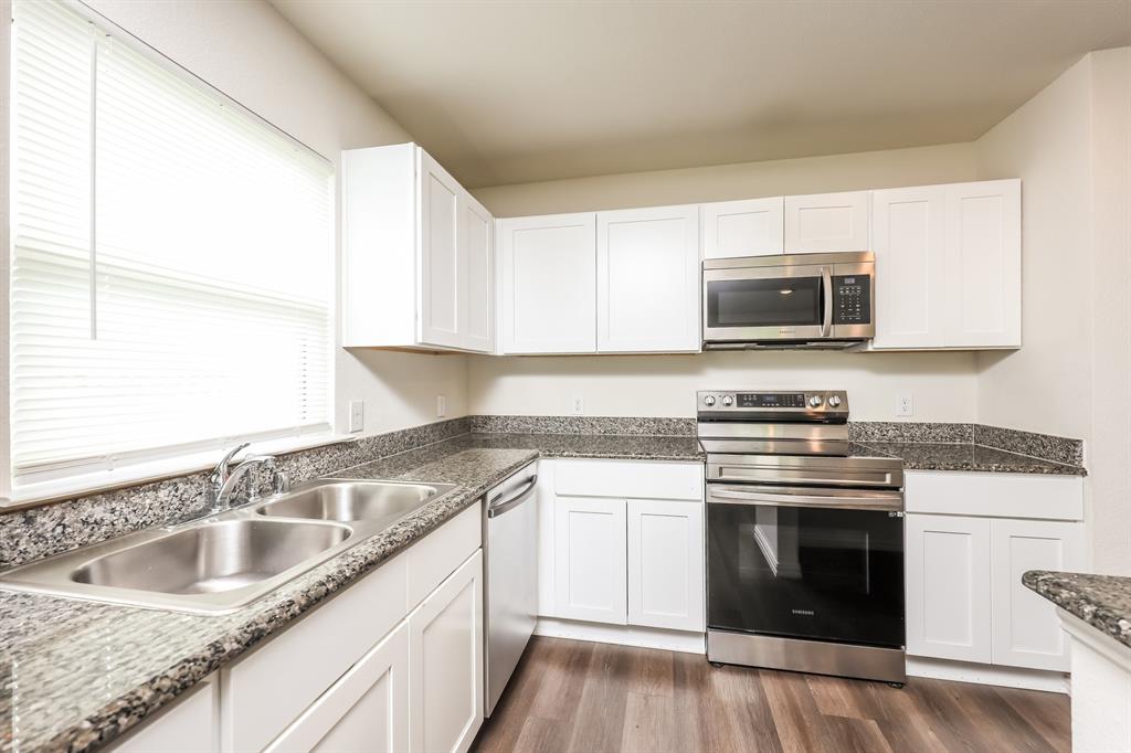 5108 Kilpatrick Avenue Fort Worth, TX 76107 - Photo 9 of 21 a kitchen with granite countertop a sink stove and microwave