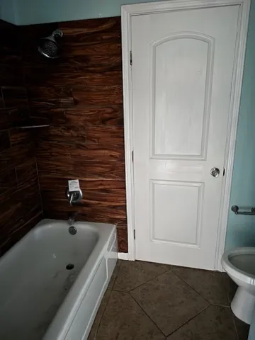 a bathroom with a bathtub and a shower