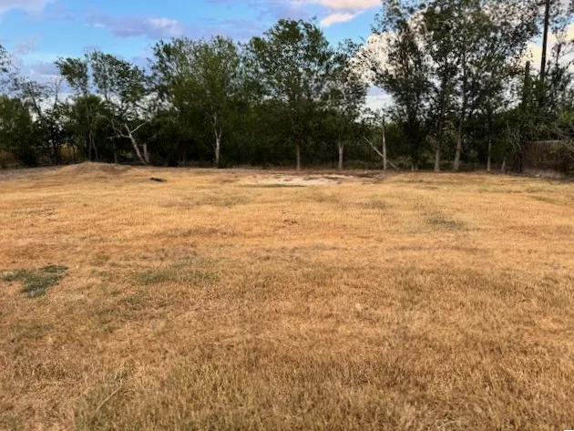 a patio with a table and chairs under an umbrella