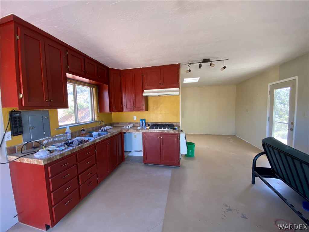 9095 Elliott Ridge Road Kingman, AZ 86401 - Photo 8 of 54 a kitchen with stainless steel appliances granite countertop a stove a sink dishwasher and cabinets with wooden floor