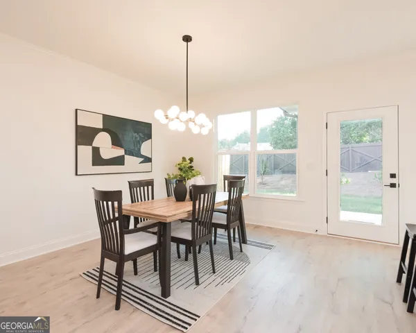 a view of a dining room with furniture window and outside view