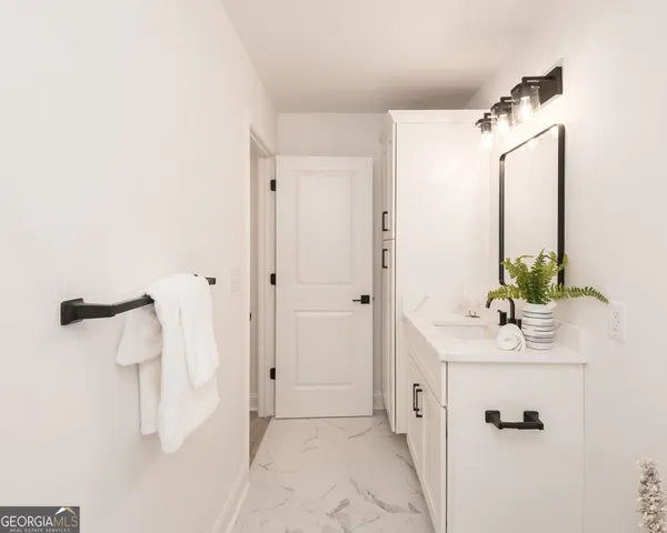 a bathroom with a sink and mirror