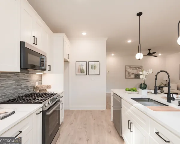 a kitchen with a sink and a stove top oven with wooden floor
