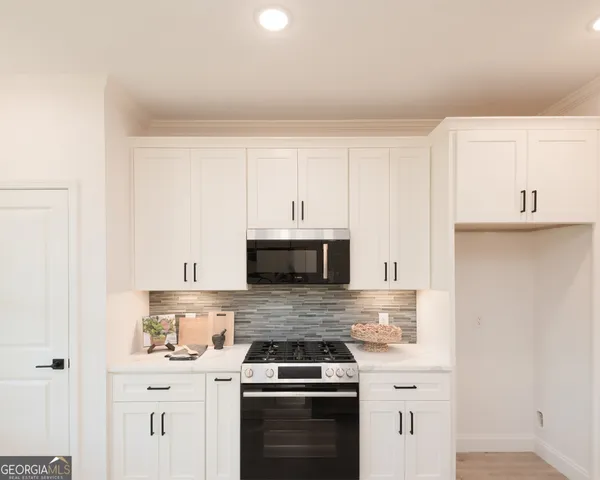 a kitchen with cabinets stainless steel appliances and a counter space