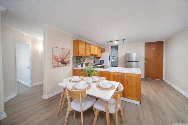 a view of a dining room with furniture and wooden floor