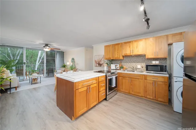 a kitchen with stainless steel appliances granite countertop a stove top oven and sink