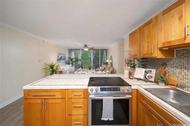 a kitchen with stainless steel appliances granite countertop a sink stove and cabinets