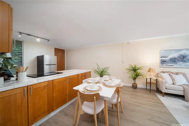 a dining room with furniture and a potted plant
