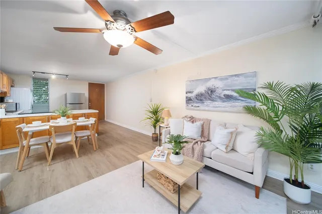 a living room with furniture a chandelier and a dining table