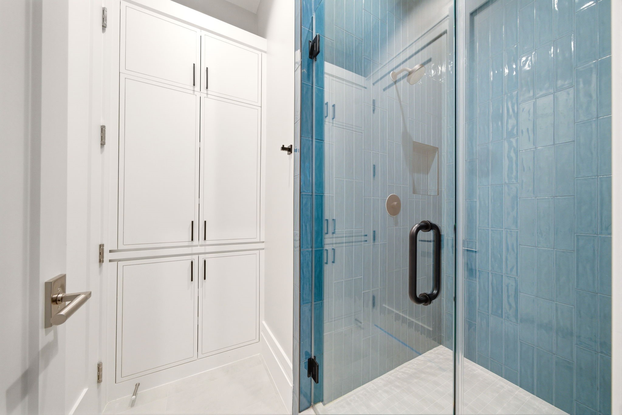 1023 Euclid Street Houston, TX 77009 - Photo 33 of 50 Ensuite bath with bold blue tile shower and plentiful cabinet storage.