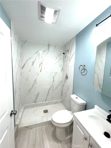 a white toilet sitting next to a bathroom sink