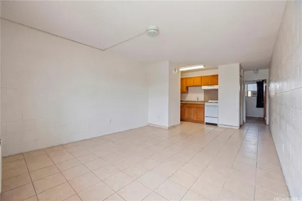 an empty room with closet and windows
