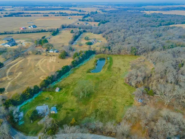 an aerial view of a houses with a yard