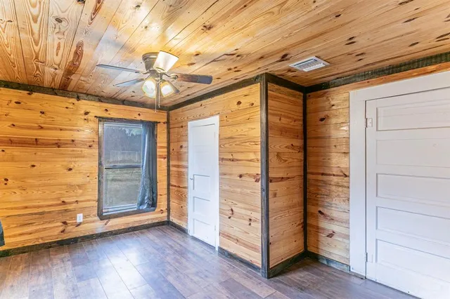 a view of walk in closet with wooden floor