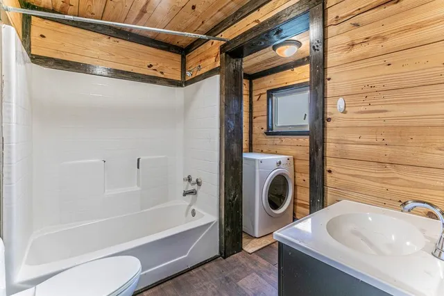a bathroom with a sink a toilet and bathtub