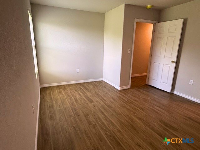 2410 Westcliff Road, Unit B Killeen, TX 76543 - Photo 12 of 21 an empty room with wooden floor and entrance