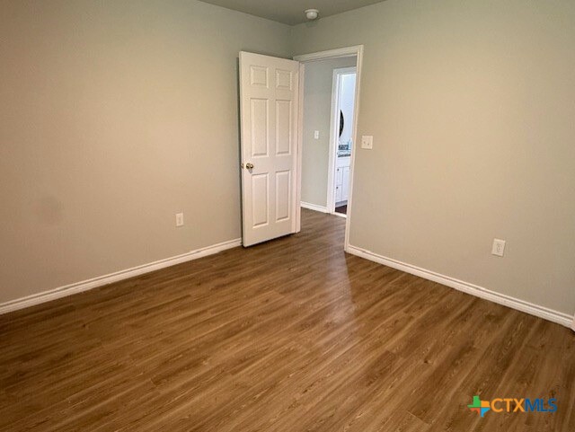 2410 Westcliff Road, Unit B Killeen, TX 76543 - Photo 9 of 21 a view of an empty room with wooden floor