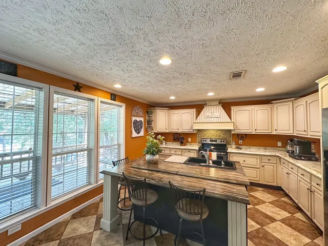 a kitchen with a table chairs refrigerator and cabinets