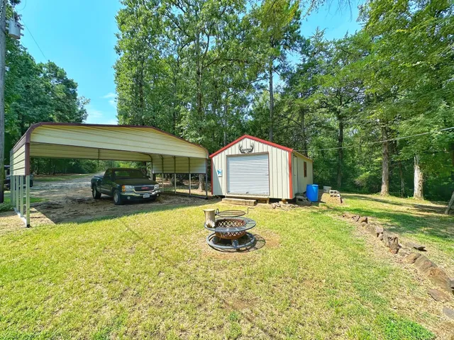 a view of a yard with large trees
