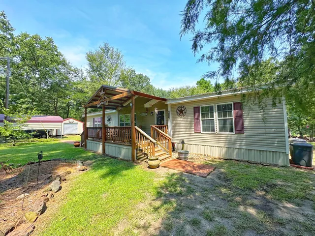 a view of a house with a yard porch and sitting area