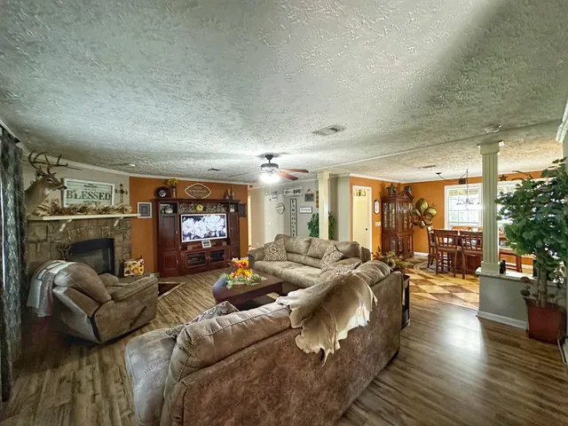 a living room with furniture fireplace and a large window