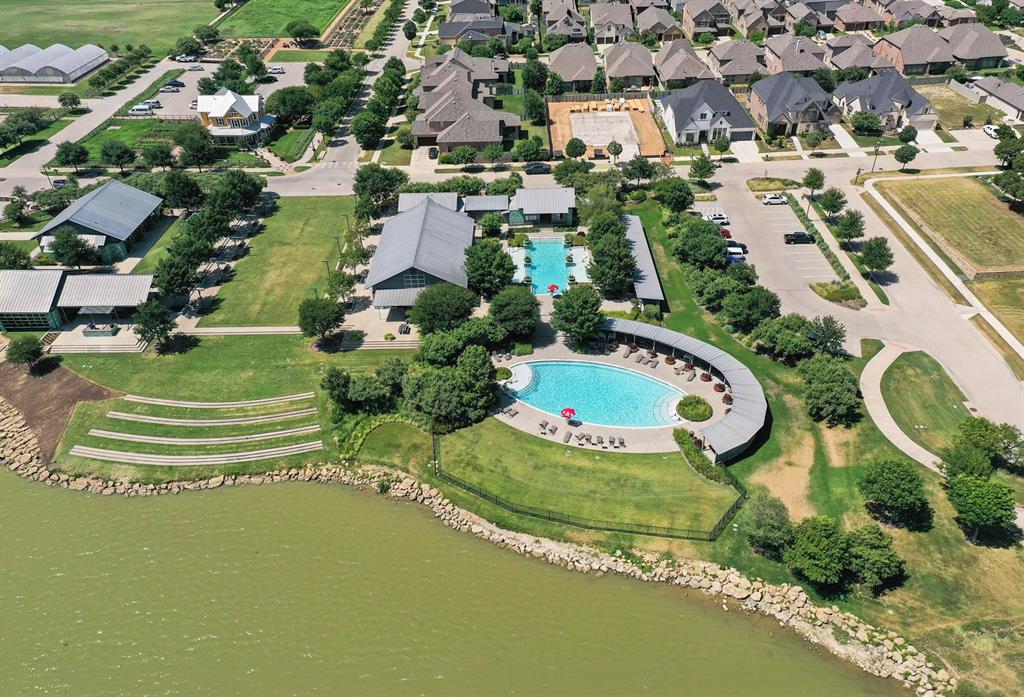421 Matchbox Street Argyle, TX 76226 - Photo 37 of 40 Aerial view showcasing a community with multiple swimming pools, extensive green spaces, and contemporary residential architecture