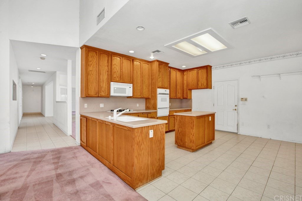 792 Gloucester Lane Thousand Oaks, CA 91362 - Photo 15 of 66 a kitchen with stainless steel appliances granite countertop a stove a sink and a refrigerator
