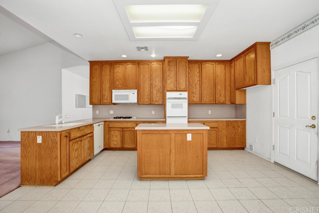 792 Gloucester Lane Thousand Oaks, CA 91362 - Photo 16 of 66 a kitchen with stainless steel appliances granite countertop a stove a sink dishwasher and a refrigerator