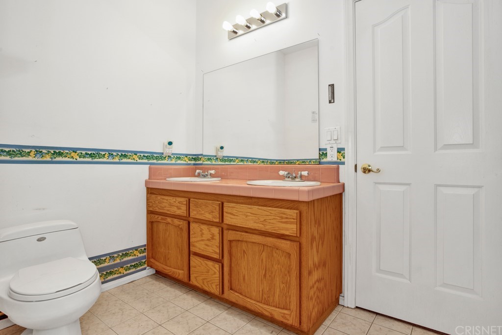 792 Gloucester Lane Thousand Oaks, CA 91362 - Photo 39 of 66 a bathroom with a sink a toilet and a mirror