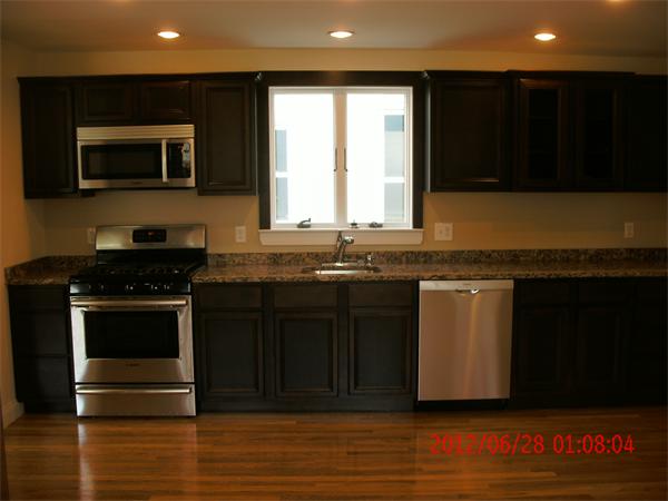 78 Taylor Street Boston, MA 02122 - Photo 3 of 13 a kitchen with granite countertop a stove and a microwave