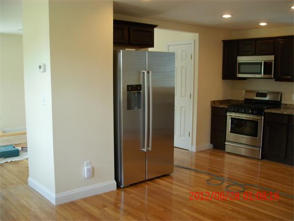 78 Taylor Street Boston, MA 02122 - Photo 5 of 13 a kitchen with stainless steel appliances granite countertop a refrigerator and a stove top oven
