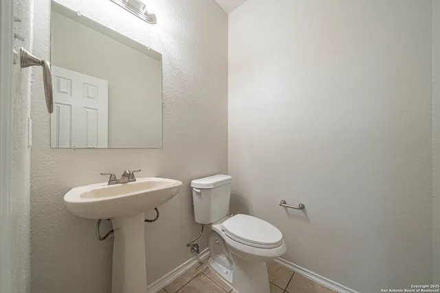 a bathroom with a sink a toilet and mirror