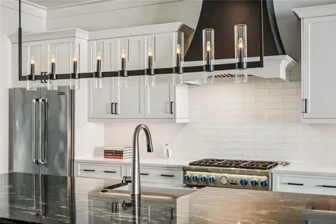 a kitchen with stainless steel appliances a stove and a refrigerator