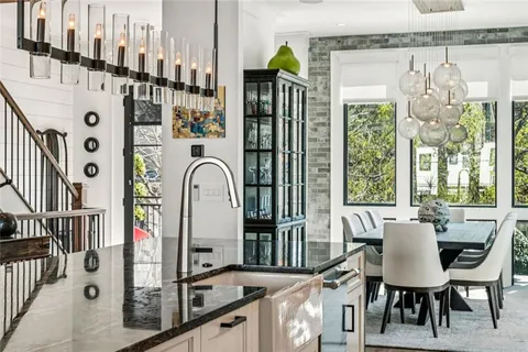 a view of a dining room with furniture and a chandelier